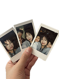 Hand holding polaroid photos